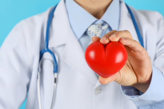 A doctor holding a cartoon-style heart