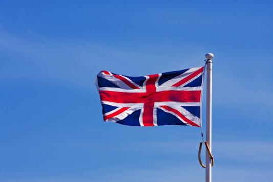 UK flag waving against a blue background
