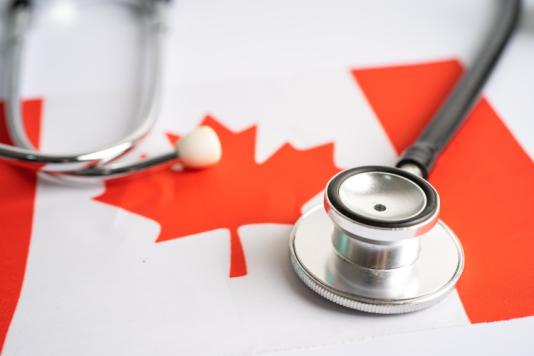 A stethoscope on top of a Canadian flag