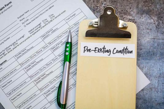 A form to indicate pre-existing conditions underneath a clipboard