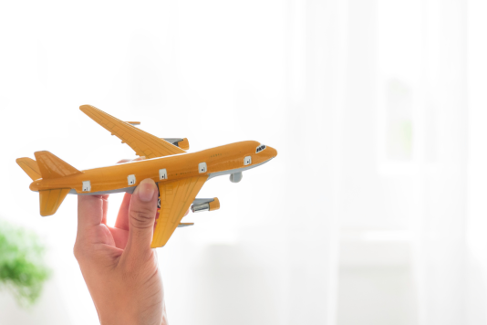 A person flying a toy plane